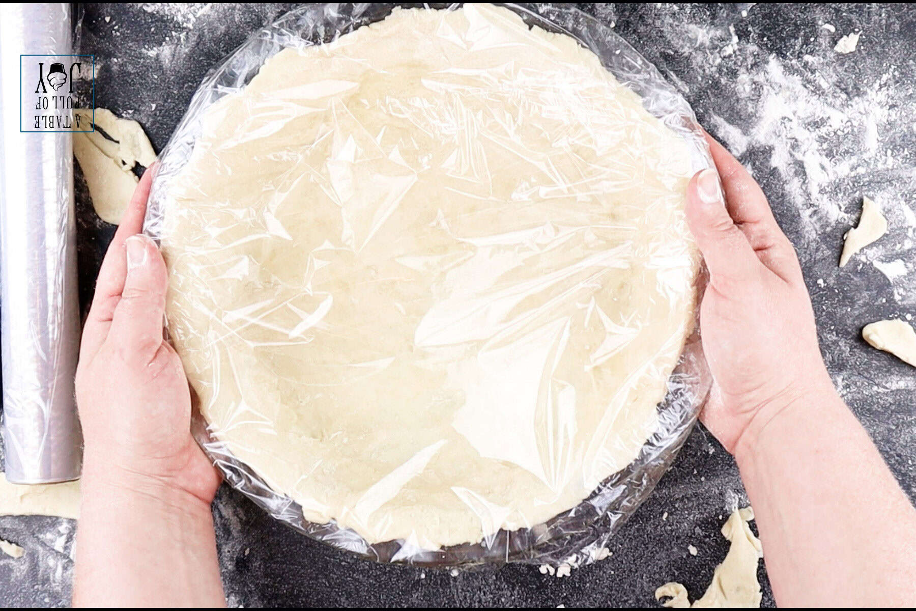 Pie dough rolled out and laid into a pie dish with the edges trimmed.