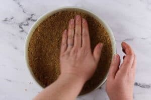 Presse graham crackers into springform dish