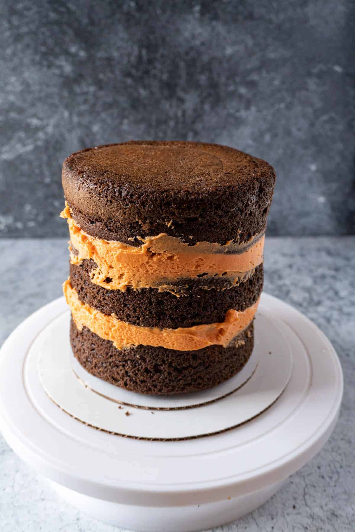 Halloween cake with all layers and filling nicely assembled- before adding the crumb coat.