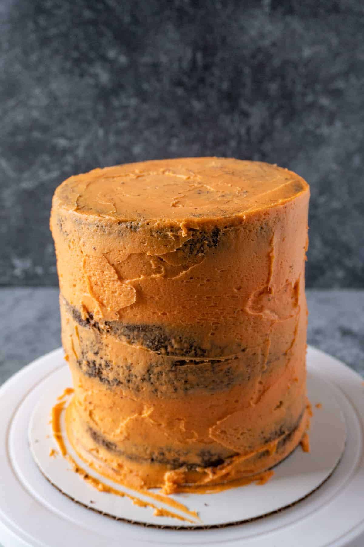 Halloween Cake with crumb coat of orange frosting.