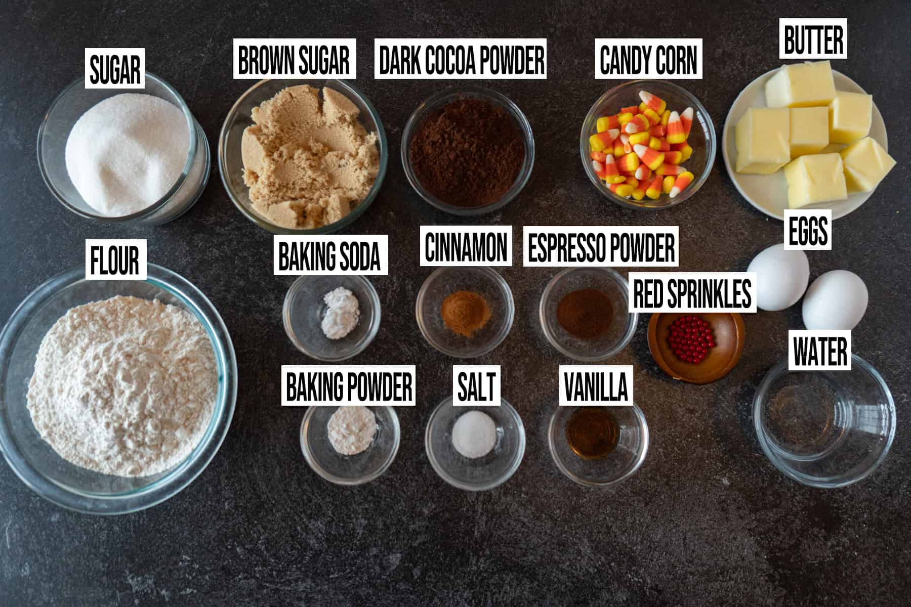 Black Cat Sugar Cookies ingredients in individual bowls and labeled.