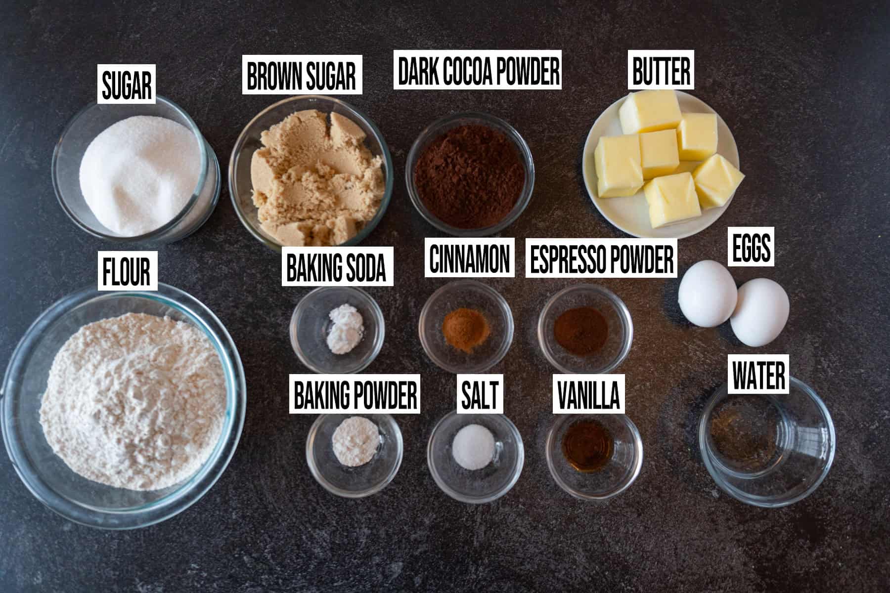 Chocolate Sugar Cookies ingredients in individual bowls and labeled.