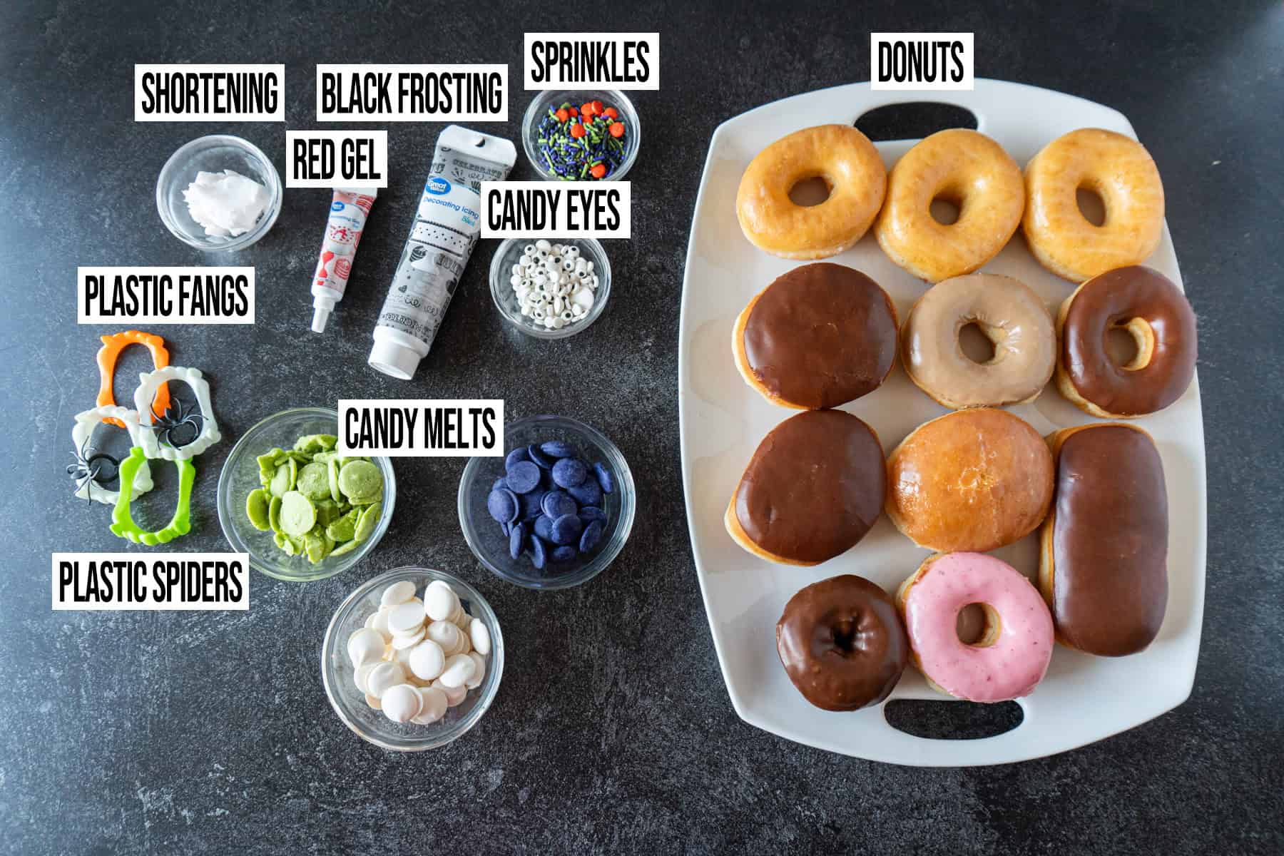 Halloween Donuts ingredients in individual bowls and labeled.