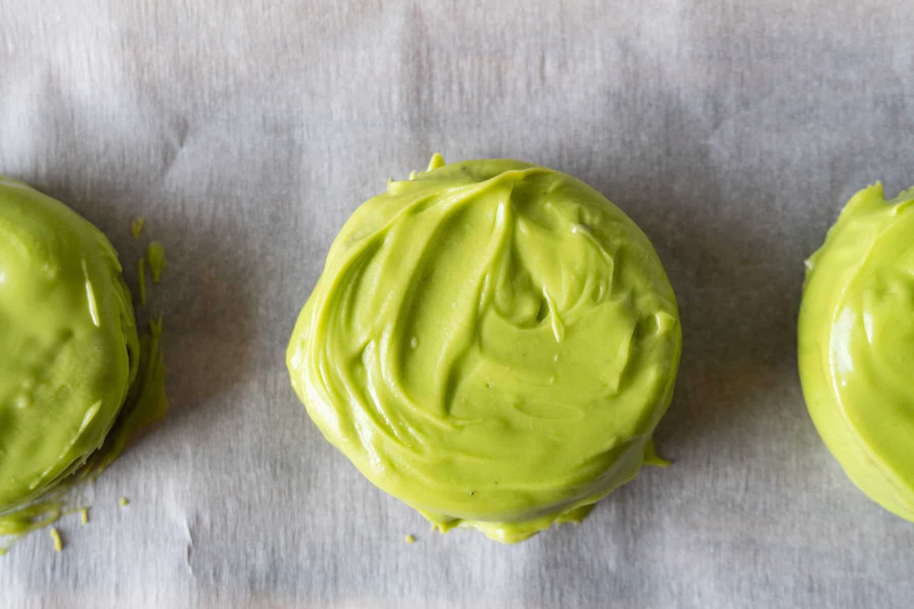 Oreo covered in green candy melts.