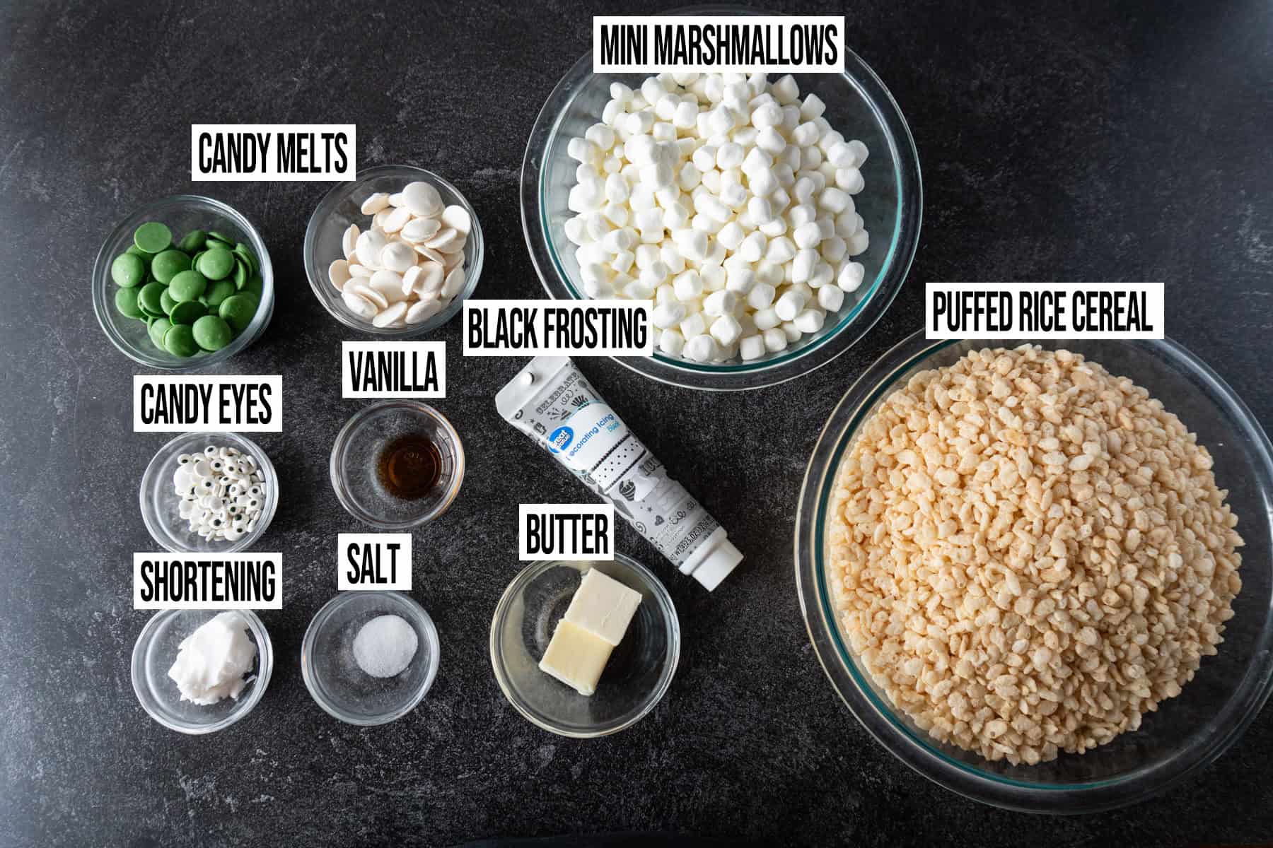 Halloween Rice Krispy Treats ingredients in individual bowls and labeled.