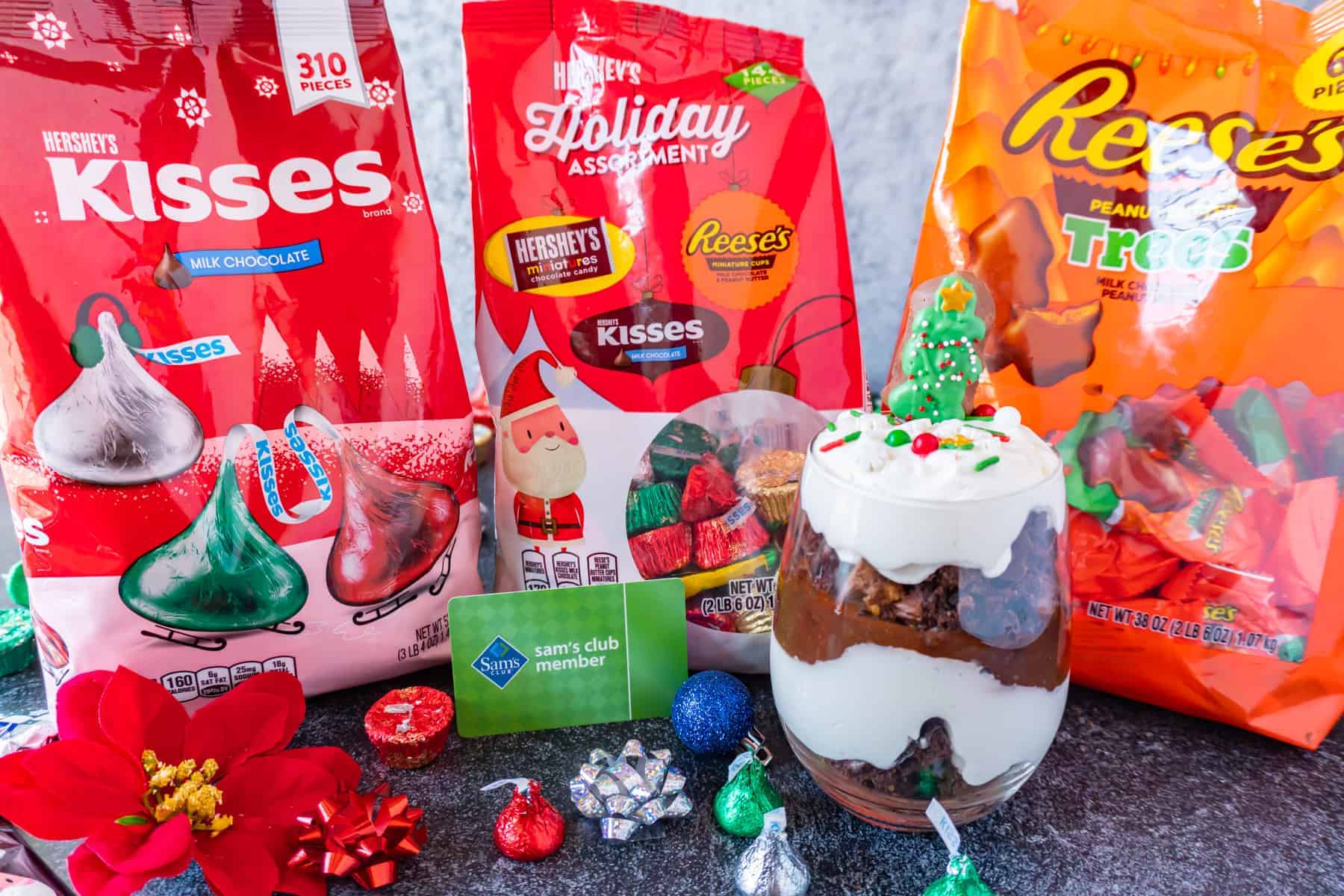 Trifle in cup next to bags of holiday candies