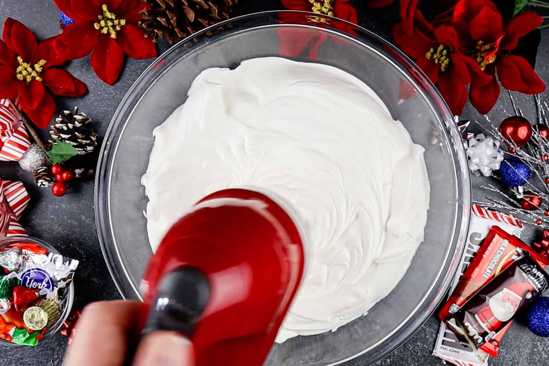Mixing whipped cream in a glass bowl.