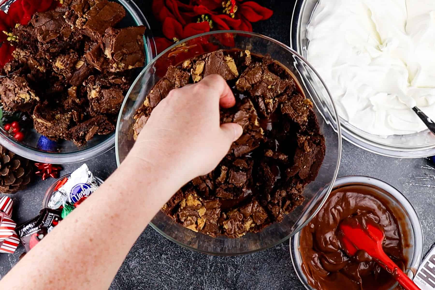 Adding brownie pieces to the bottom of the trifle dish.