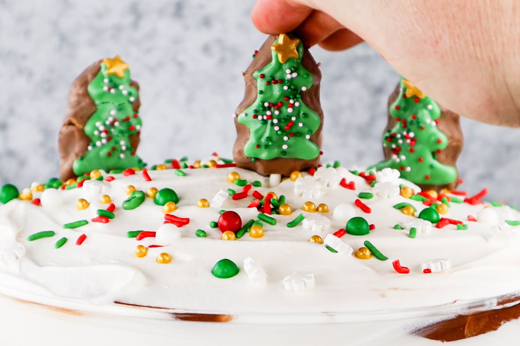 Add decorated REESE's tree and sprinkles to the top of the trifle.