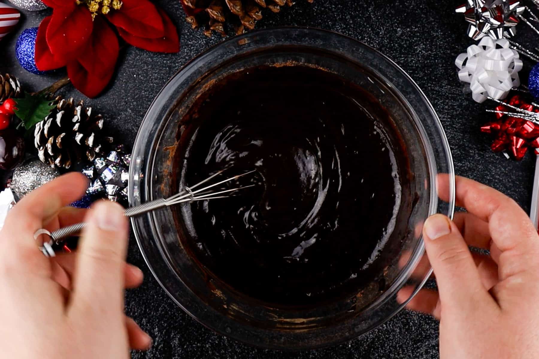 Melted butter and cocoa powder mixture in glass bowl.