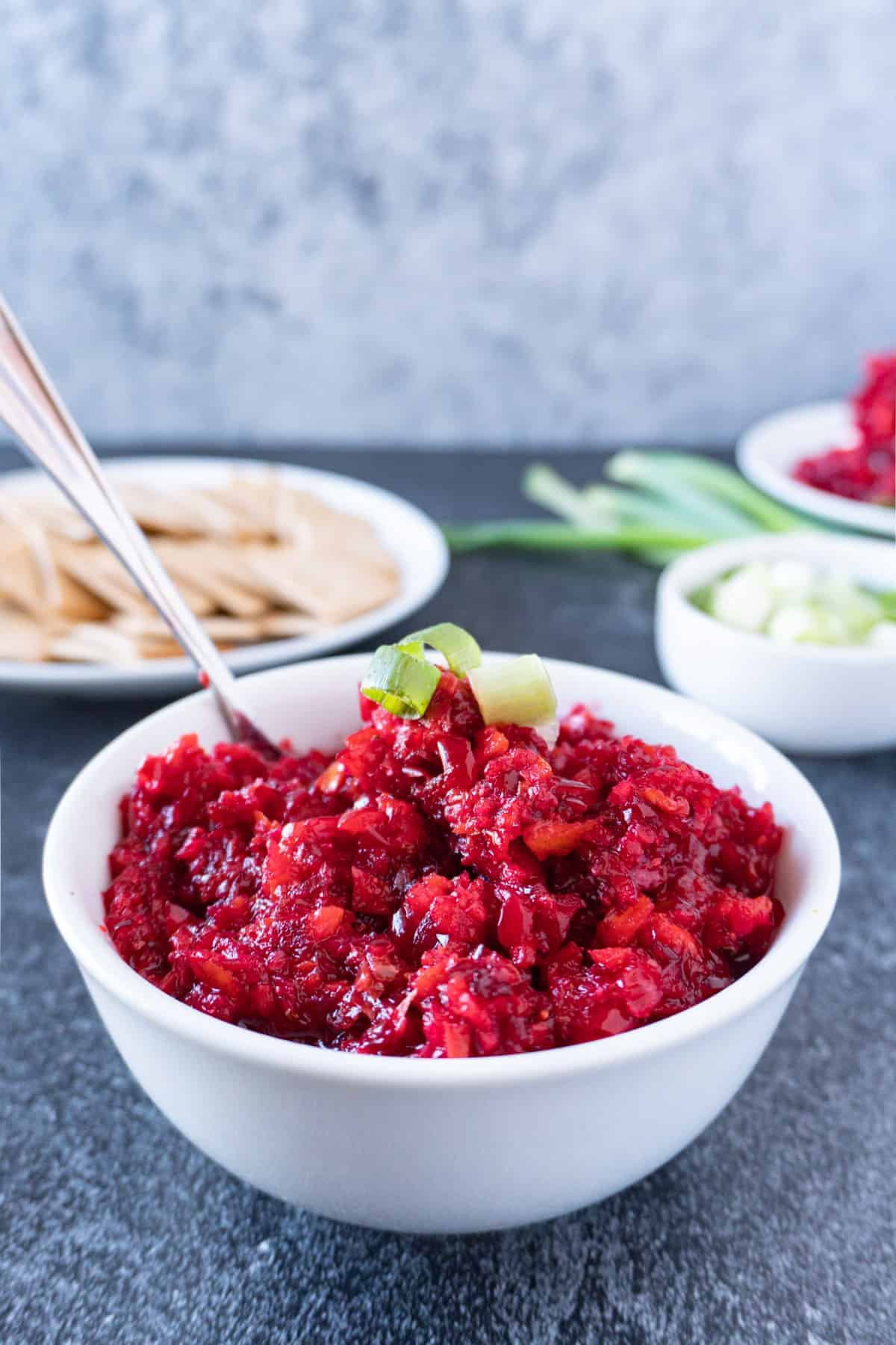 cranberry relish in bowl with green onion on top