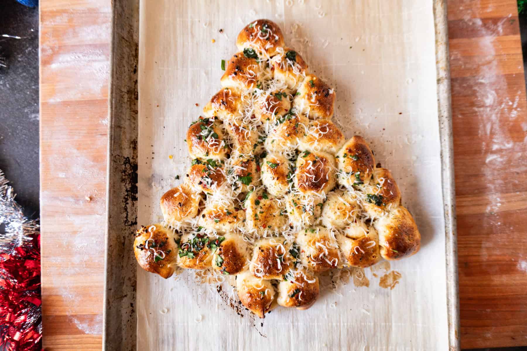 christmas appetizer after baking, on baking sheet, brushed with herbs and butter.