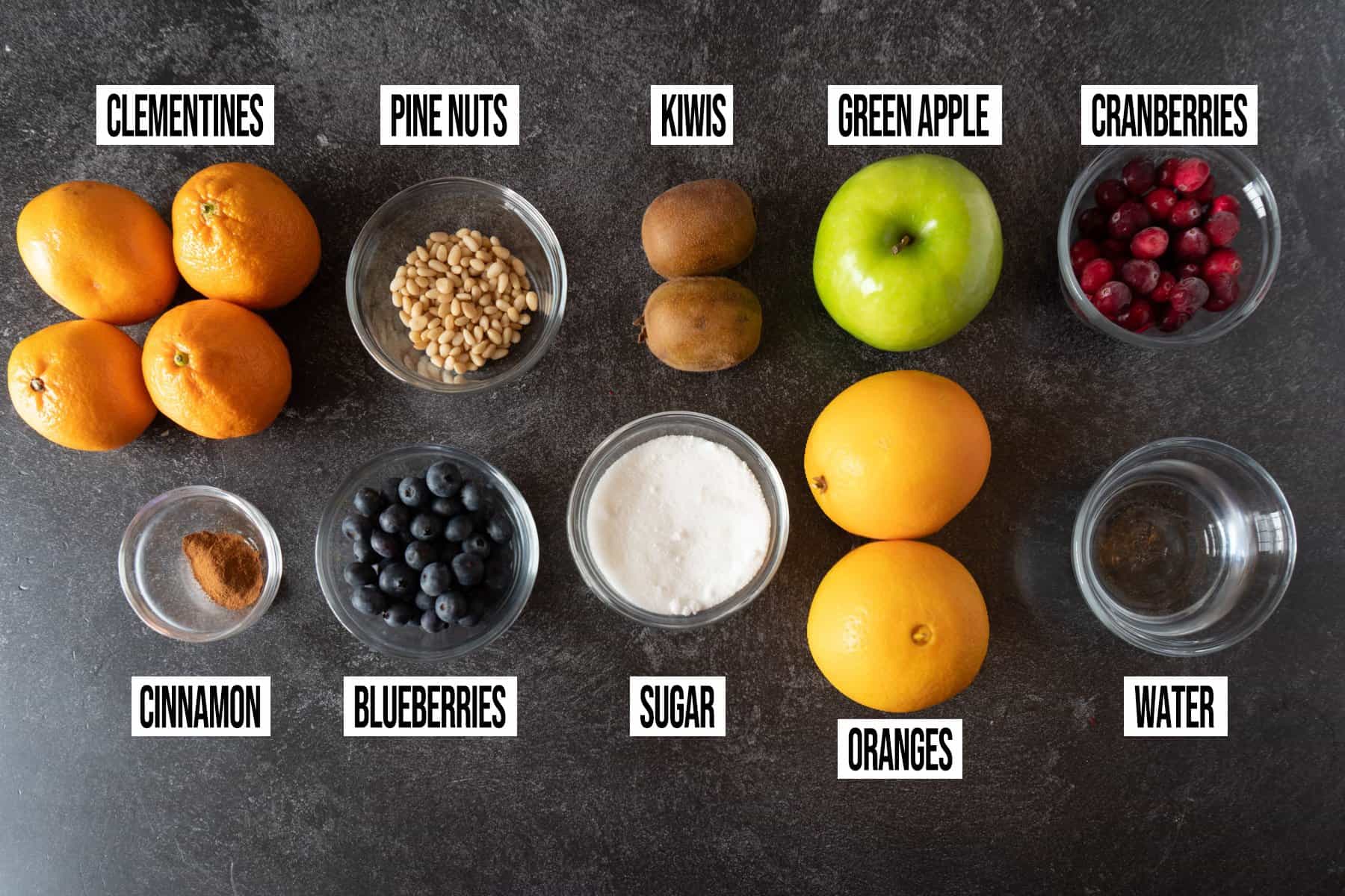 Christmas Fruit Salad Ingredients in individual bowls and labeled