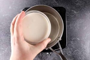 heavy cream being added to sauce pan