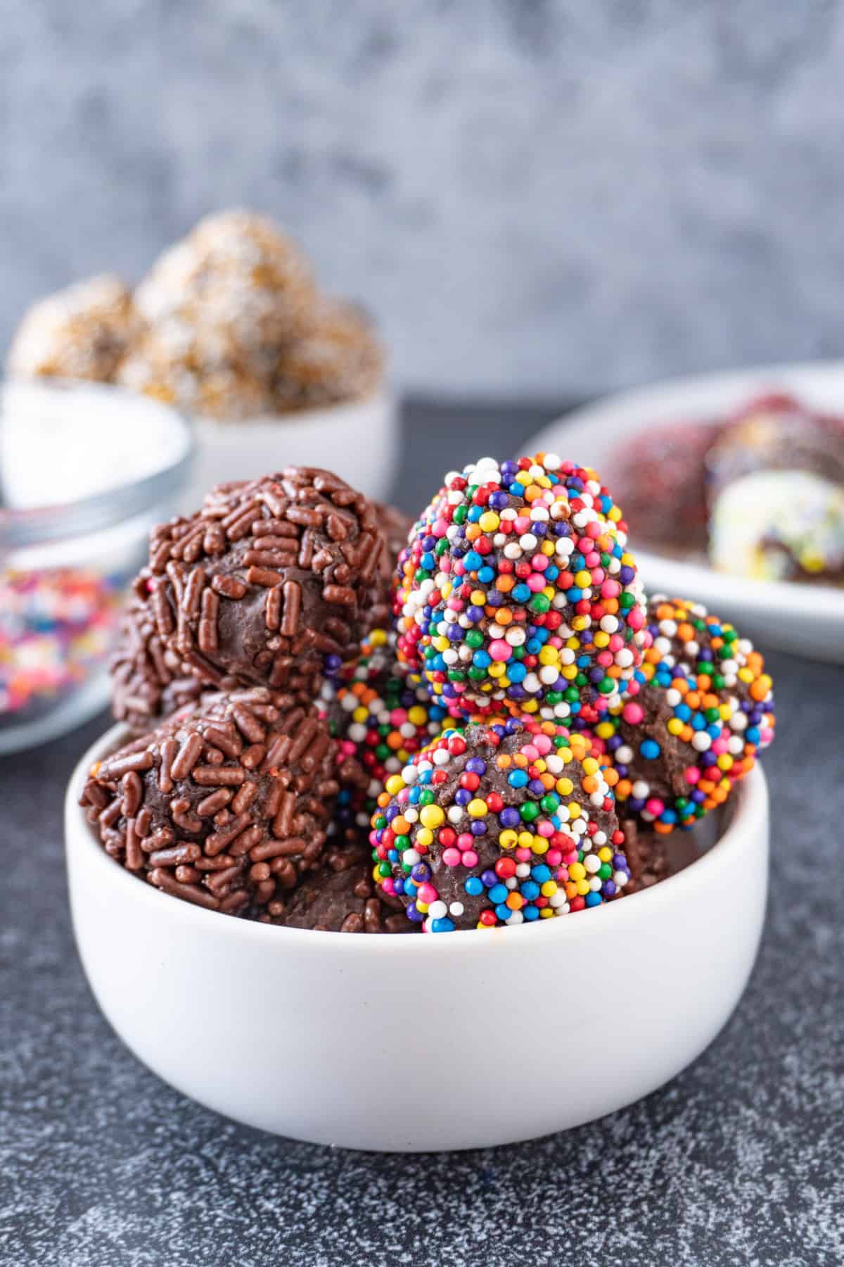 chocolate truffles with rainbow and chocolate sprinkles close up