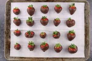 strawberries dippe din chocolate on parchment paper