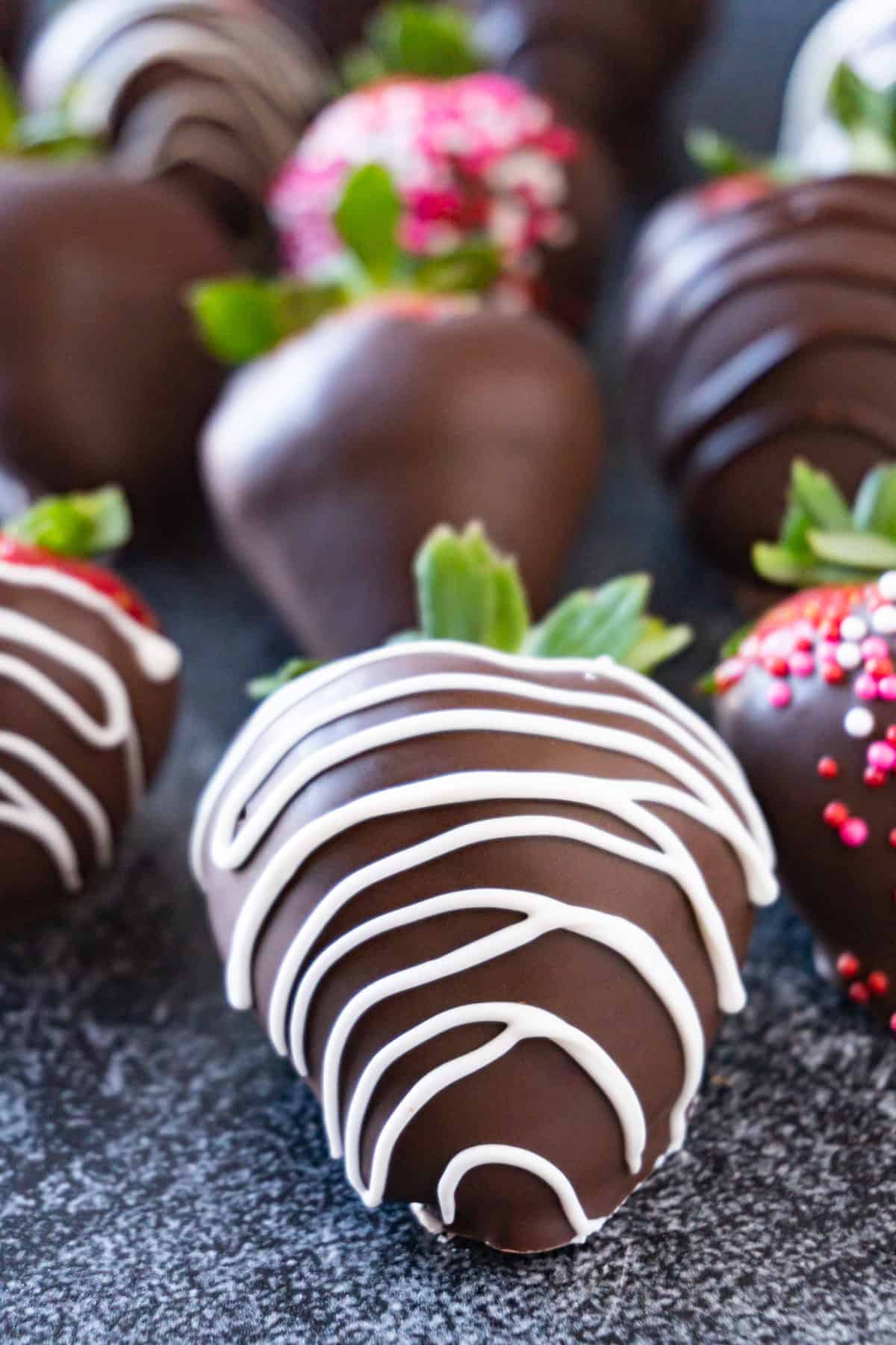 chocolate covered strawberry with strips on it