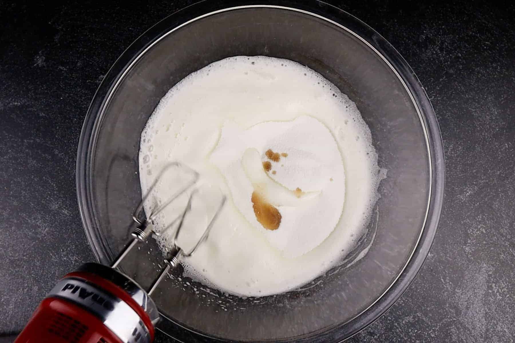 adding sugar and vanilla to meringue