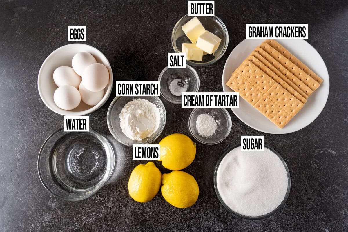 lemon meringue pie with graham cracker crust ingredients labeled in individual bowls.
