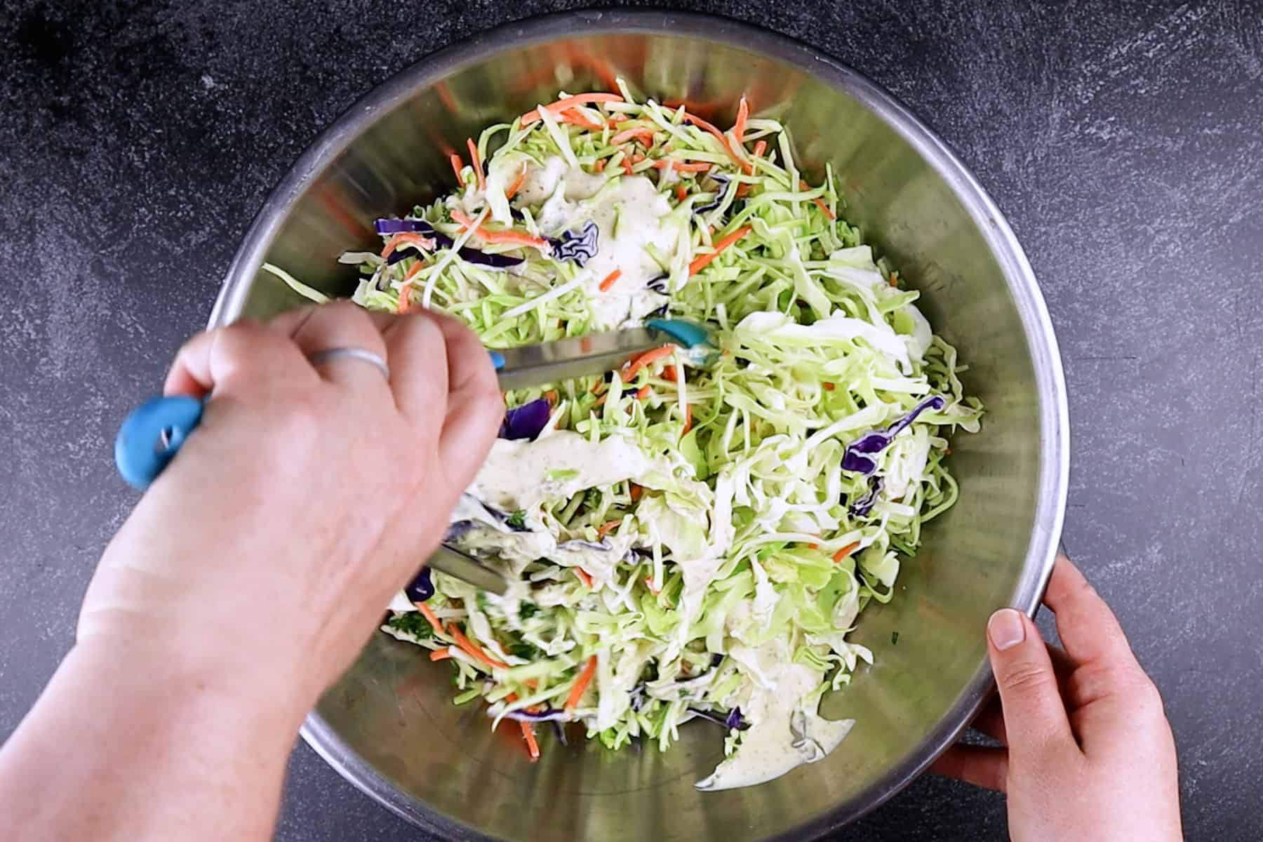 mixing the broccoli slaw