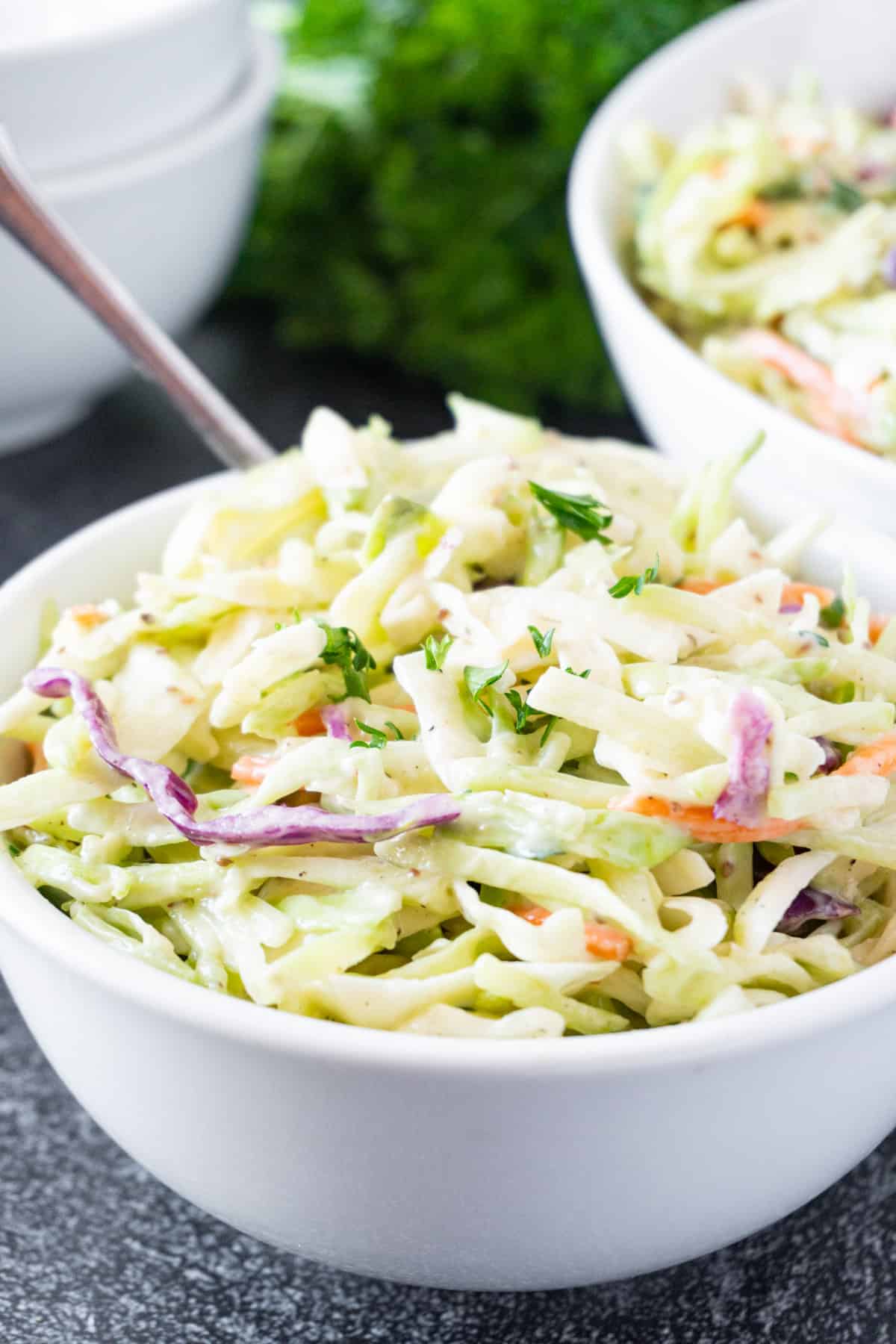 broccoli coleslaw in bowl with fork