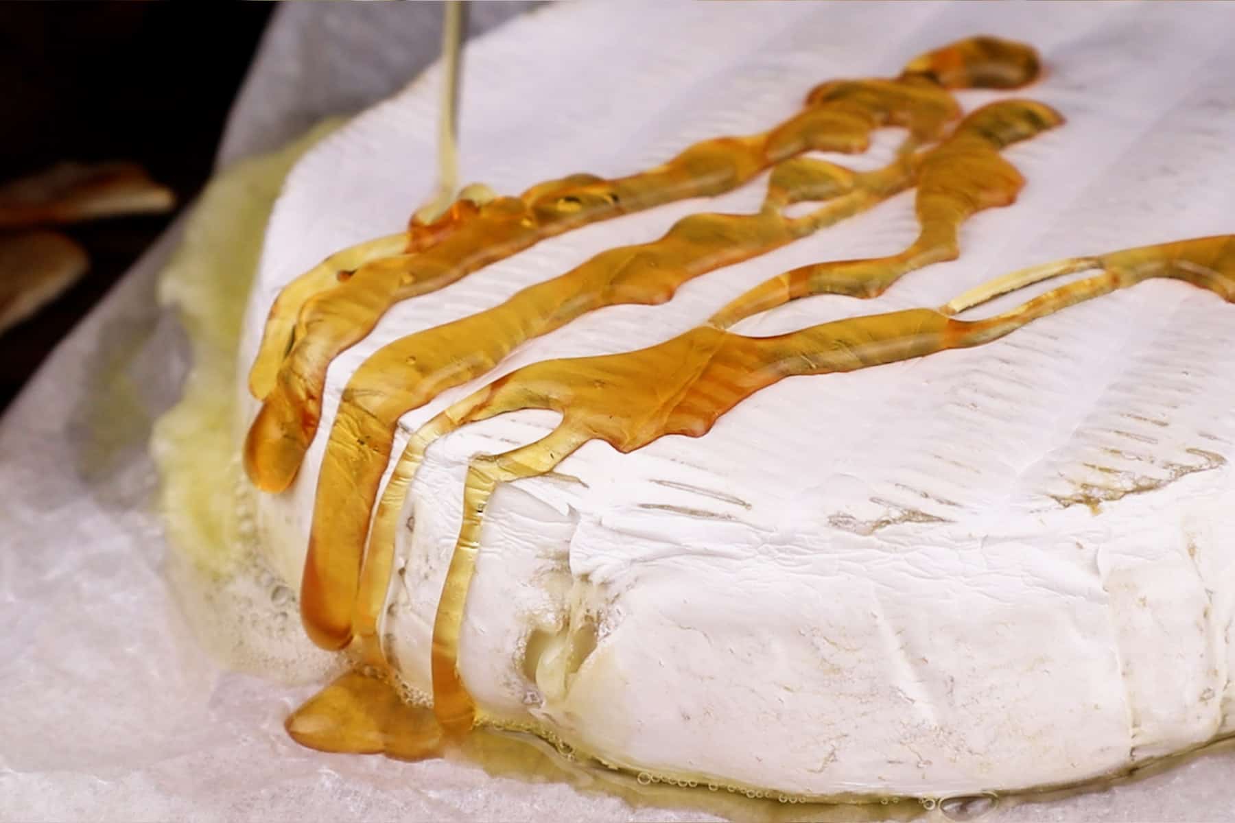 pouring honey on baked brie