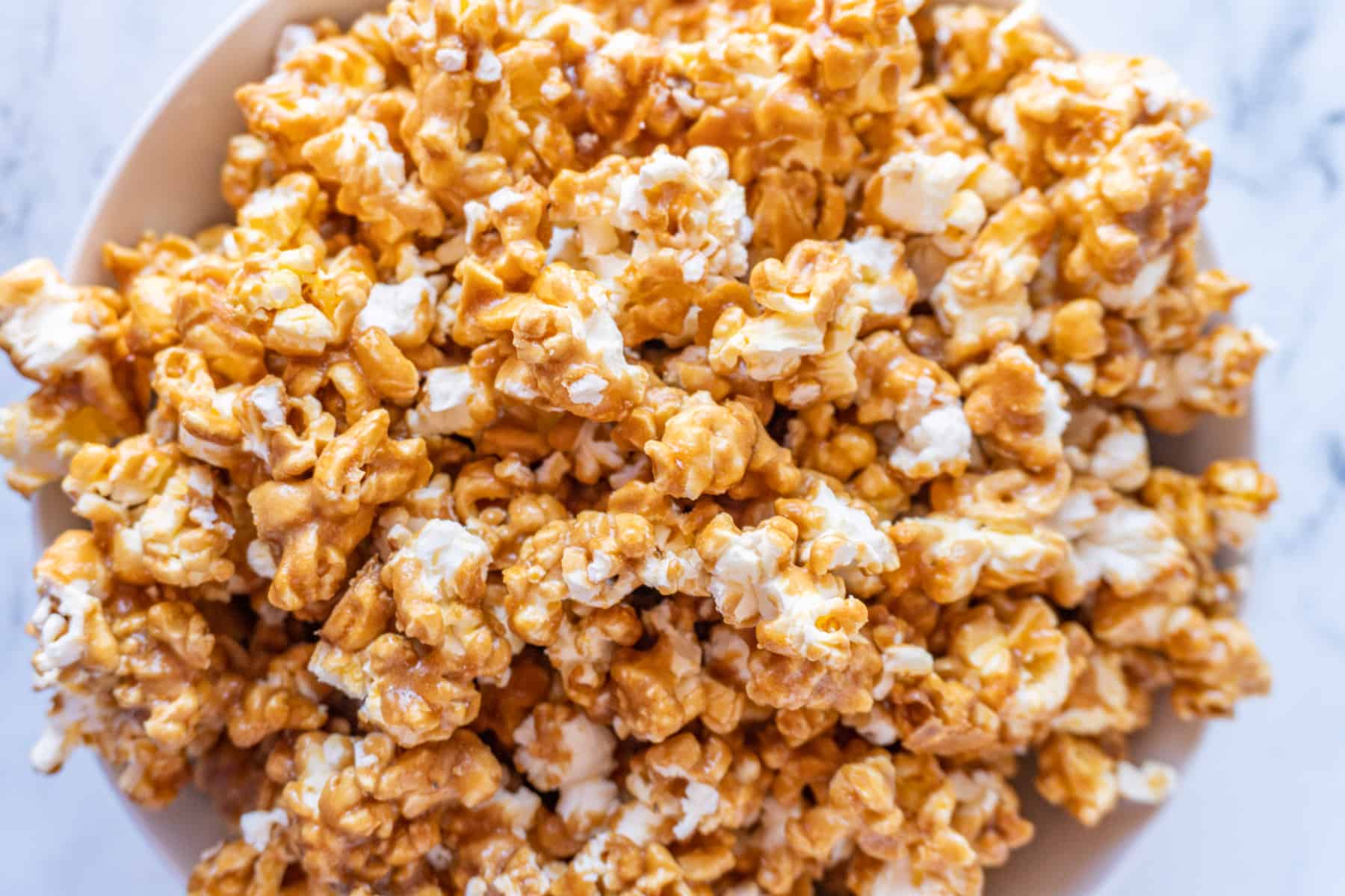 caramel popcorn in large bowl overhead shot