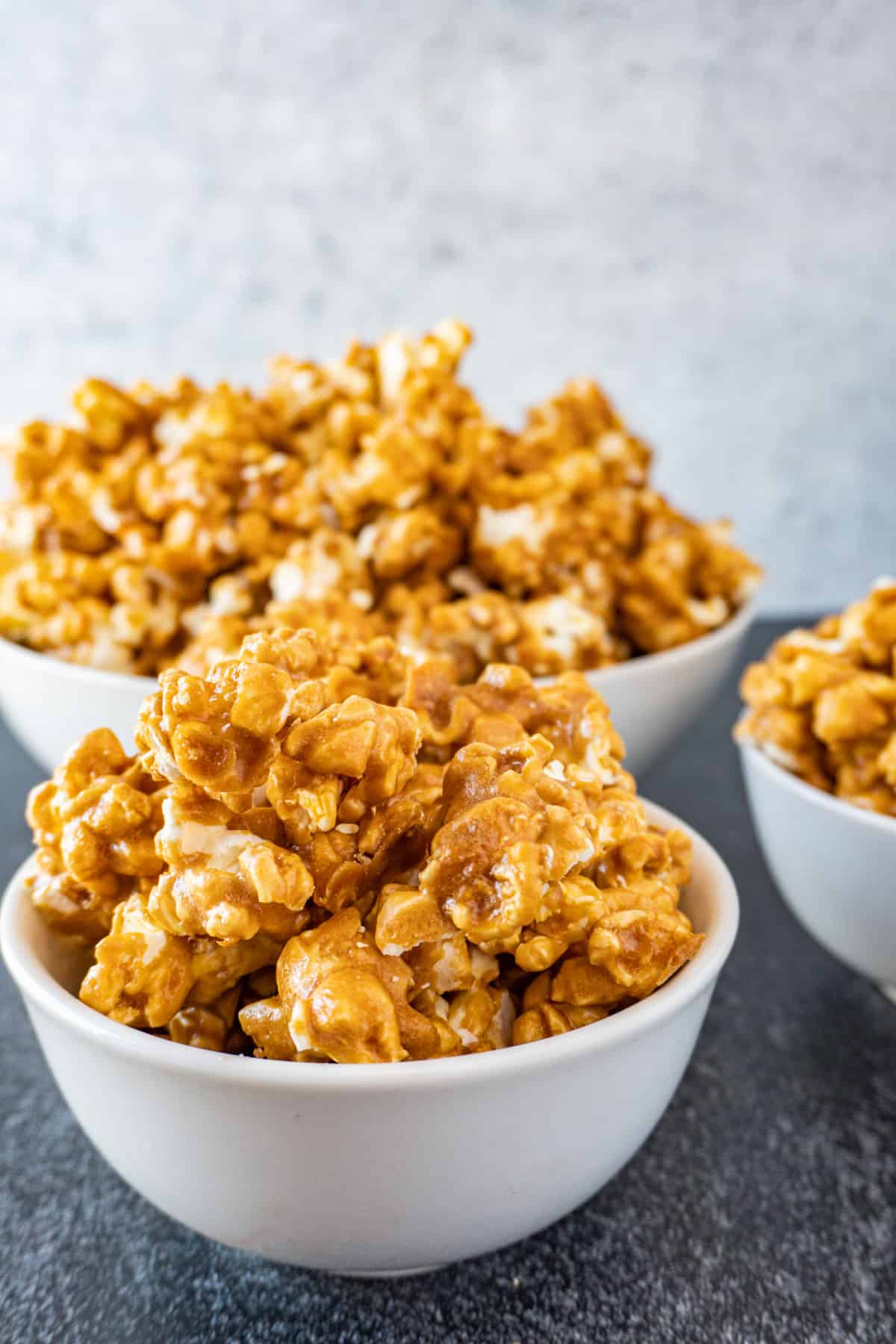 caramel popcorn in multiple bowls