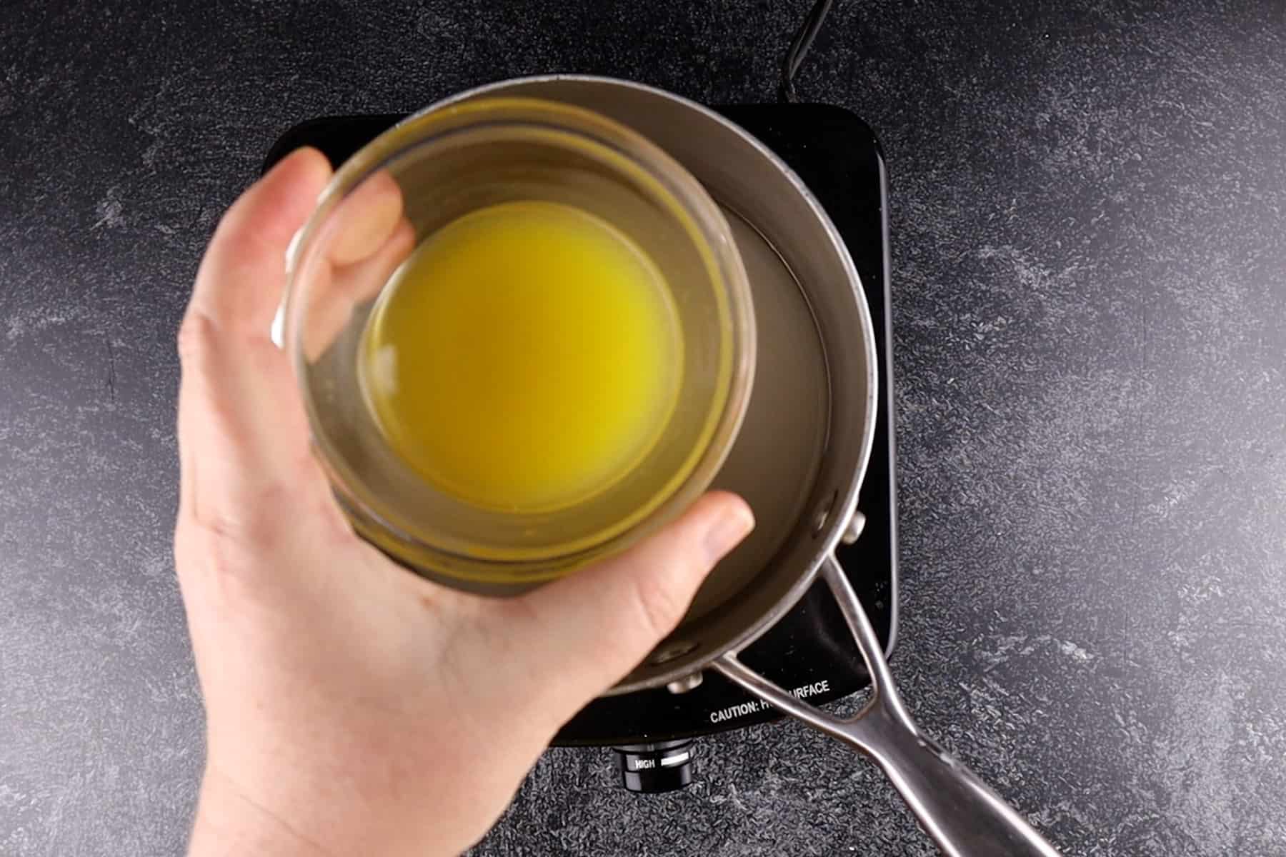 adding orange juice to sauce pan