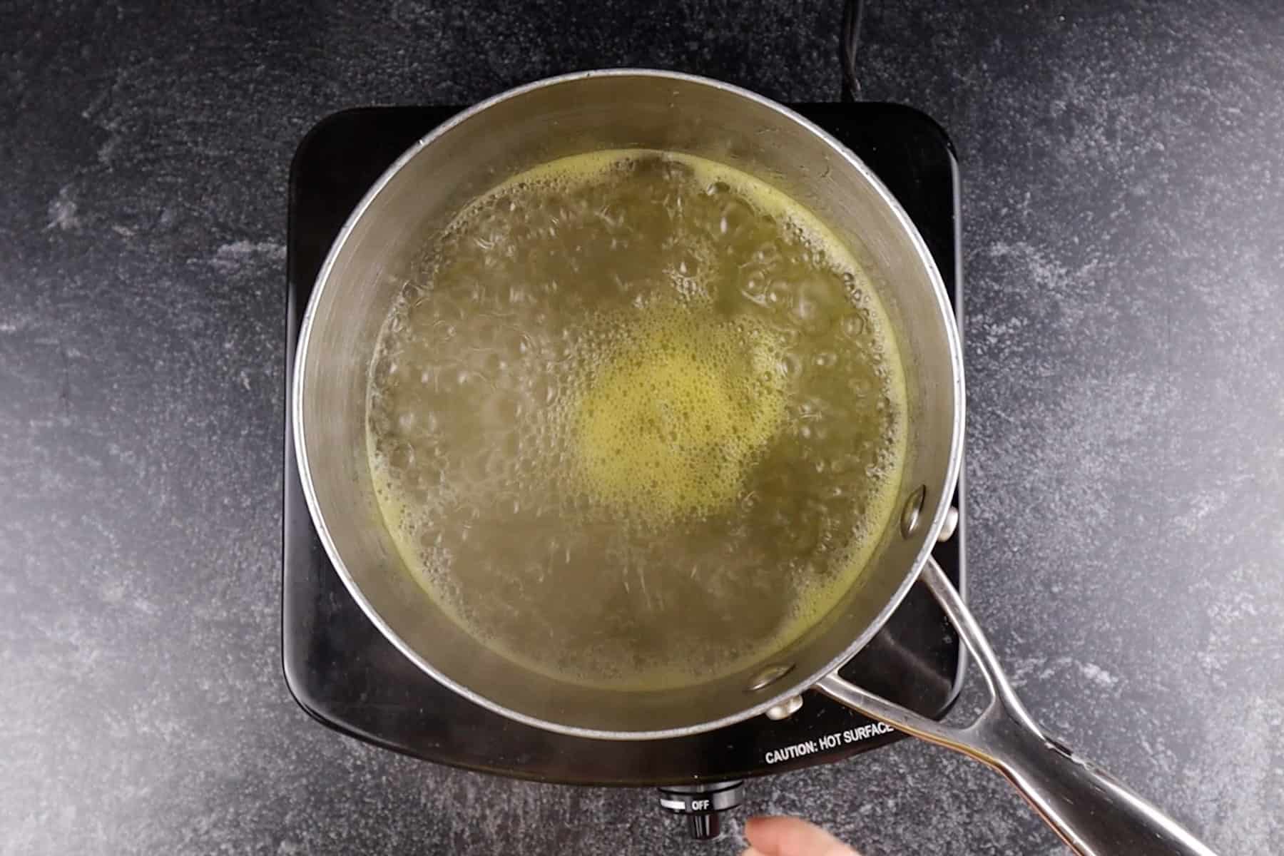 boiling the sugar, water, and orange juice