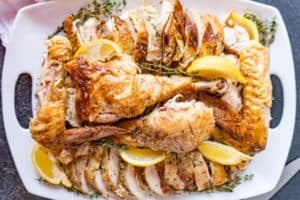 cut turkey on platter with lemons