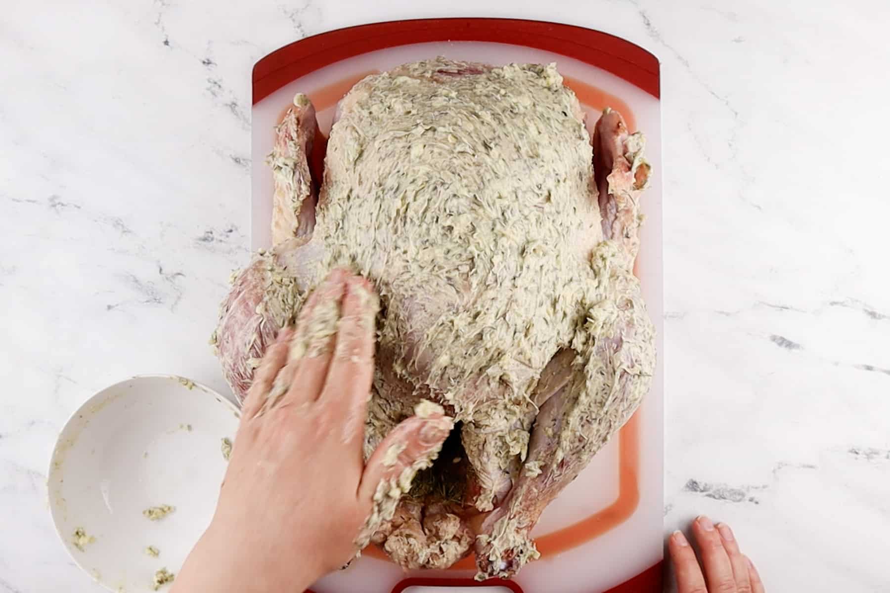 rubbing butter over turkey