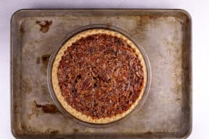 baked pecan pie on baking sheet