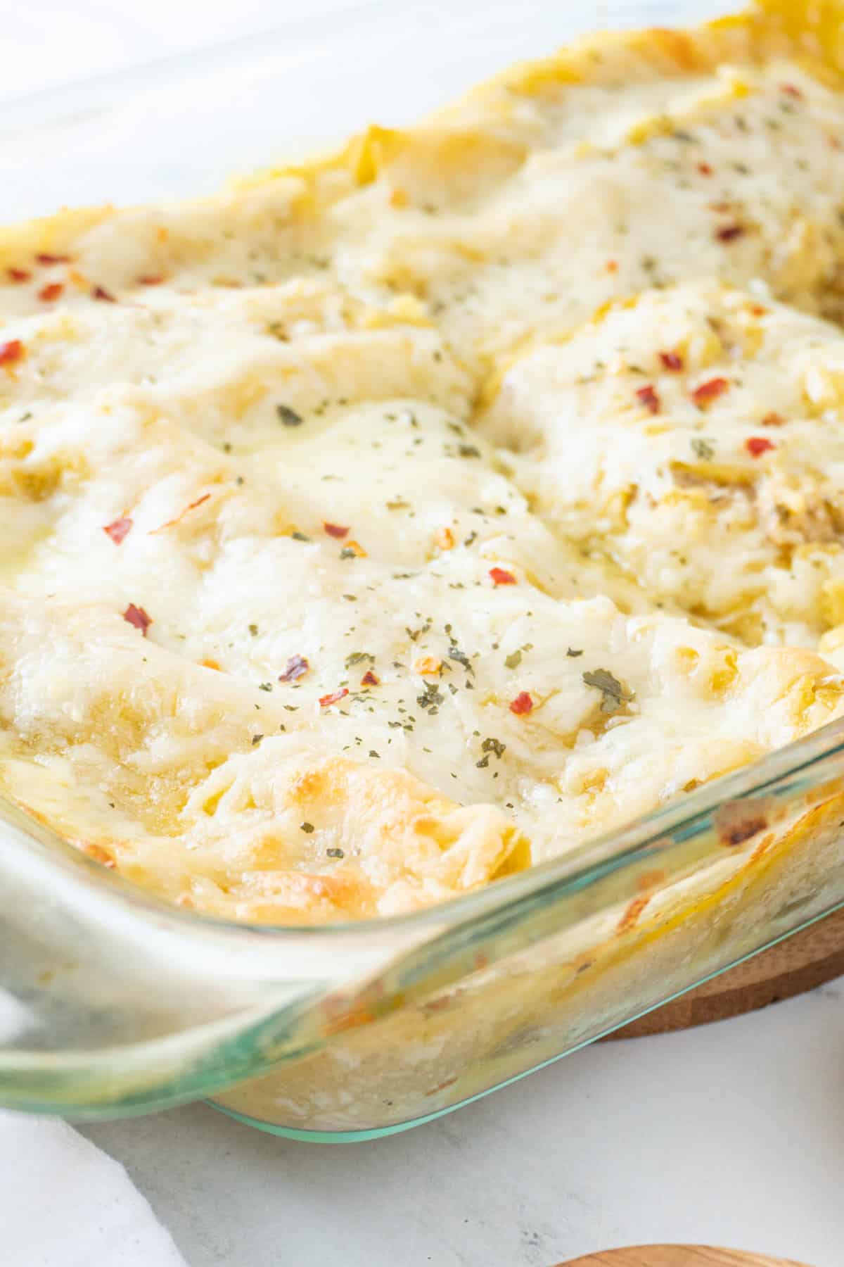 close up of enchiladas in baking dish