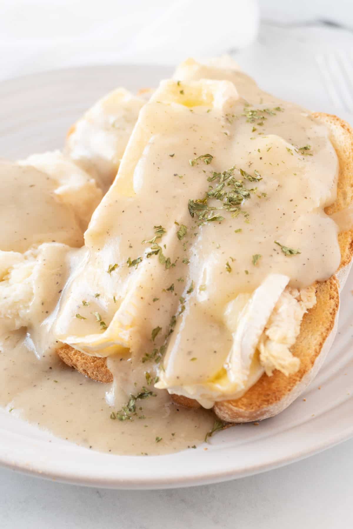 open faced turkey sandwich with brie and gravy