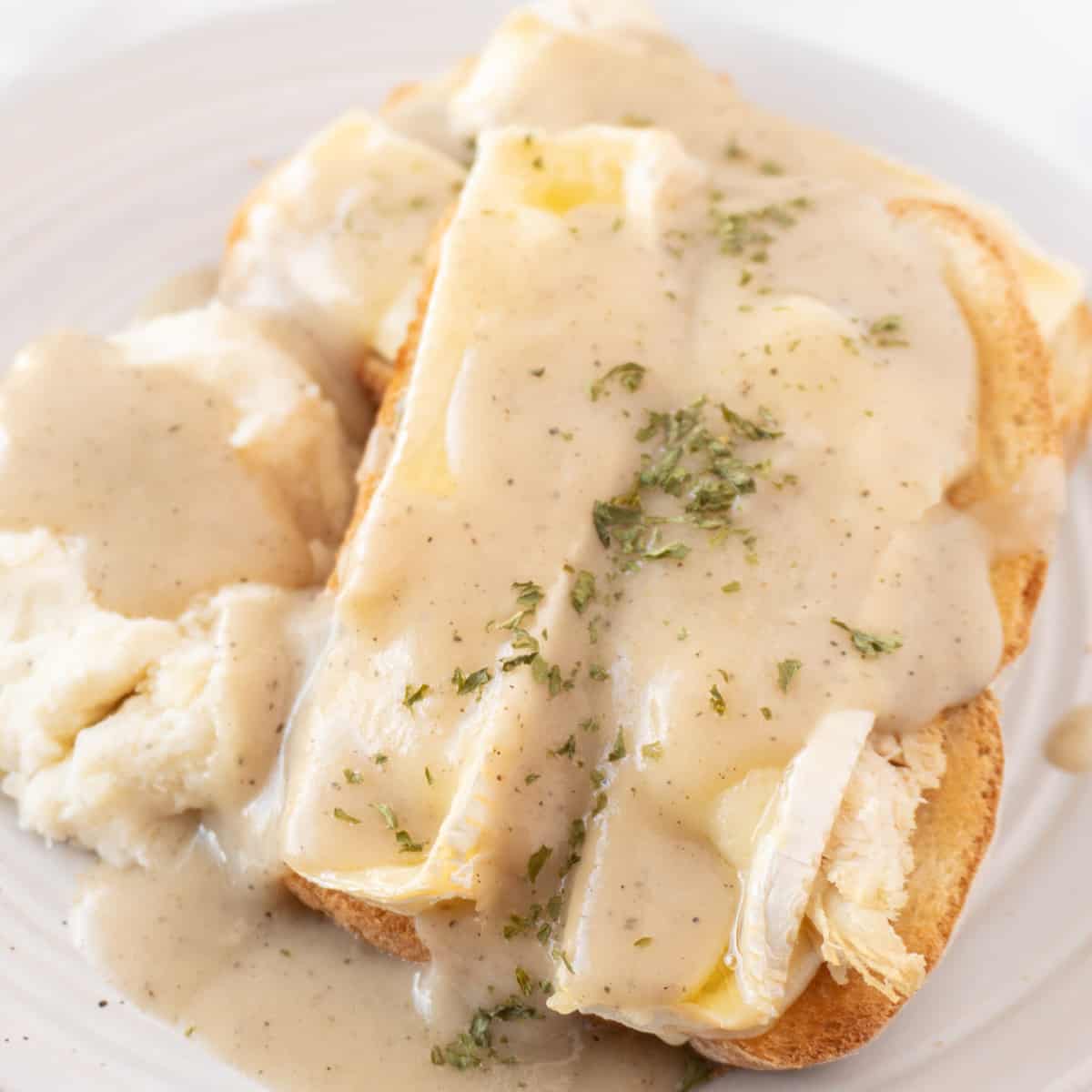 hot turkey sandwich with gravy on plate close up featured image