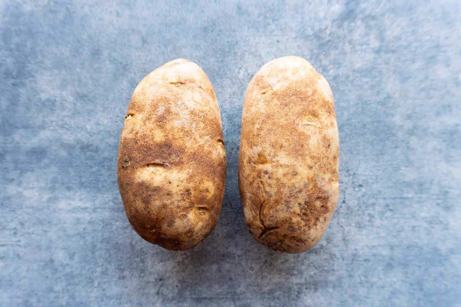 two russet potatoes side by side