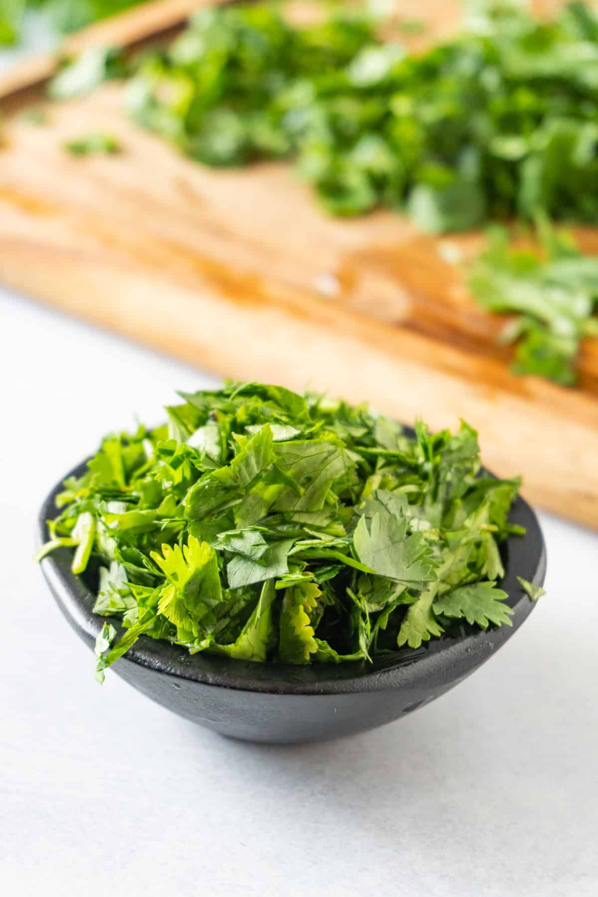 chopped cilantro in black bowl