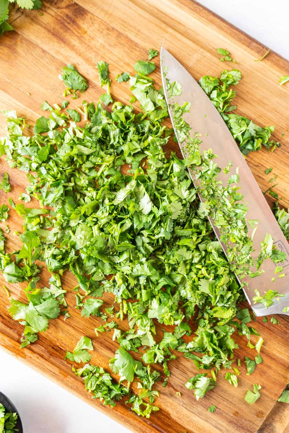 cilantro chopped on cutting board with knife