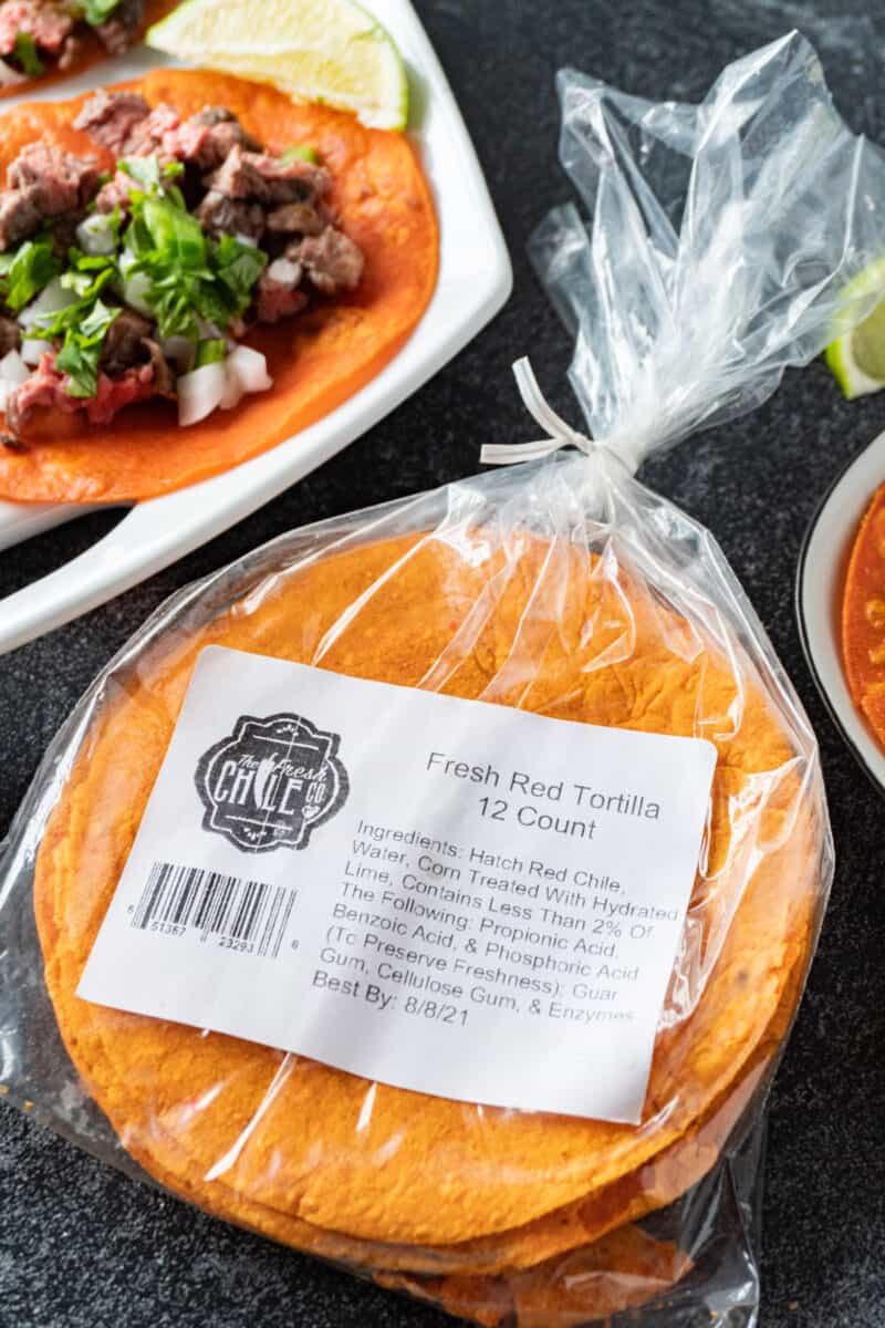 red chile corn tortillas in package with tacos in background