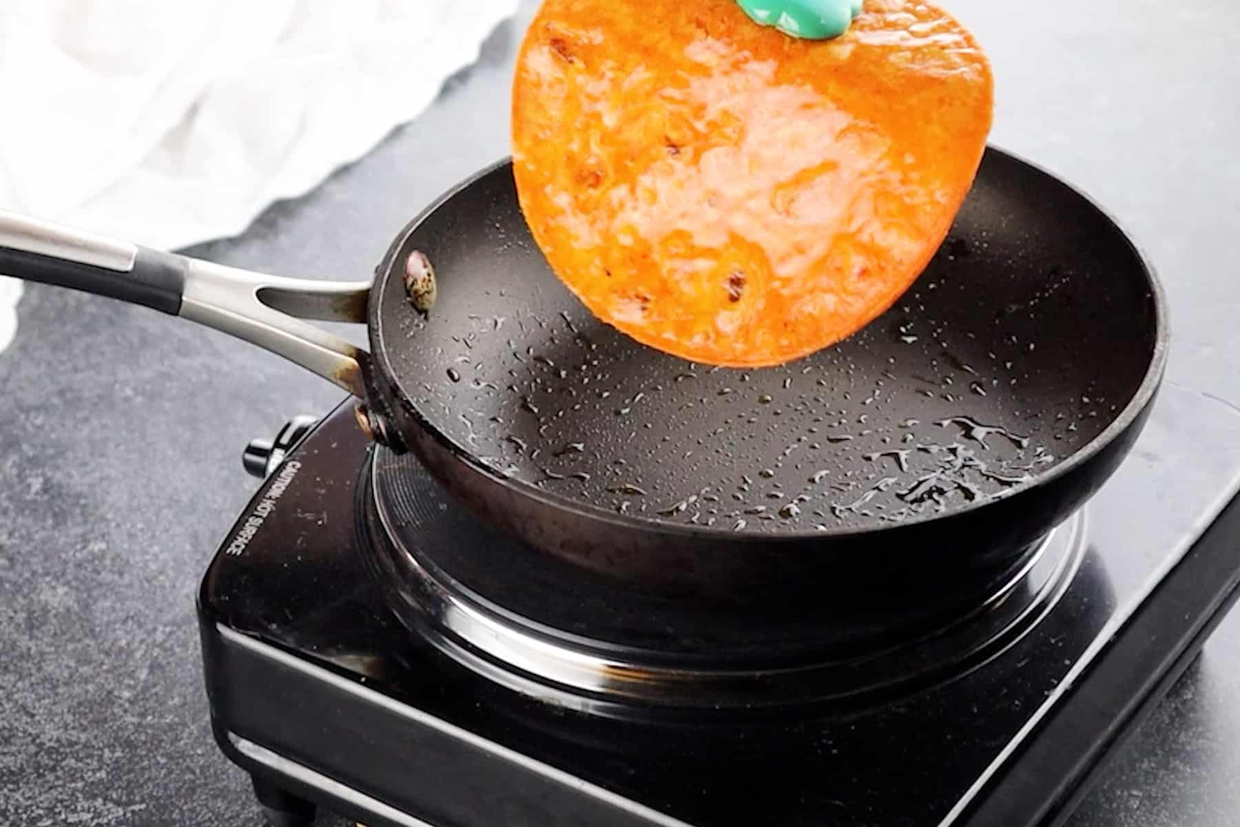 frying a tortilla in a frying pan