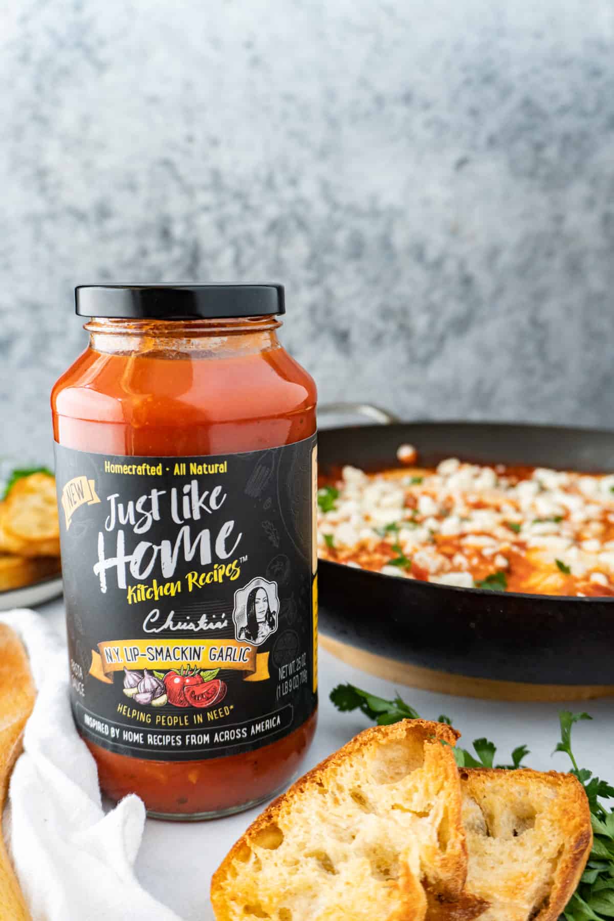 pasta sauce jar with shakshuka in background