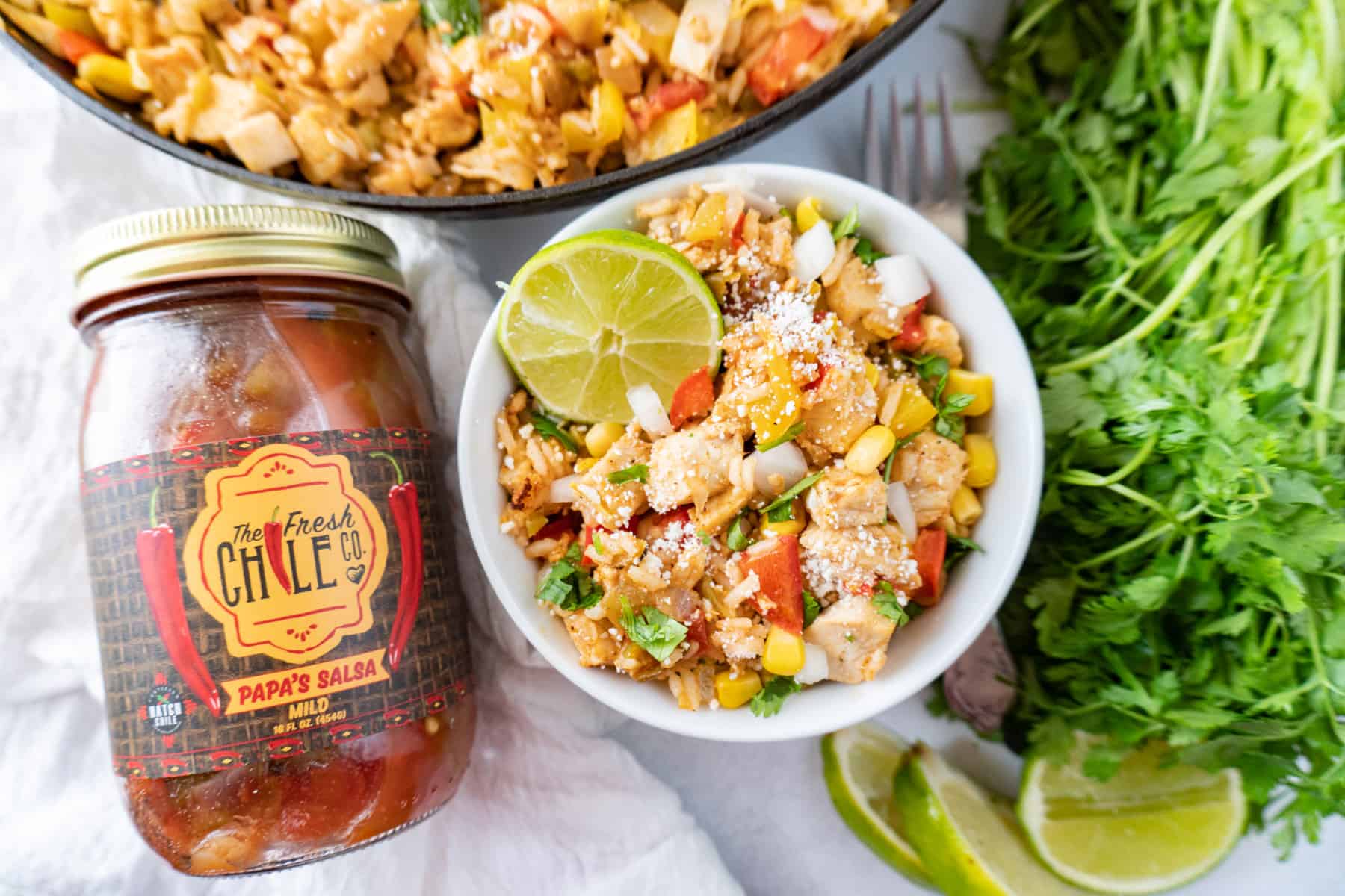 southwest chicken in bowl with salsa jar next to it