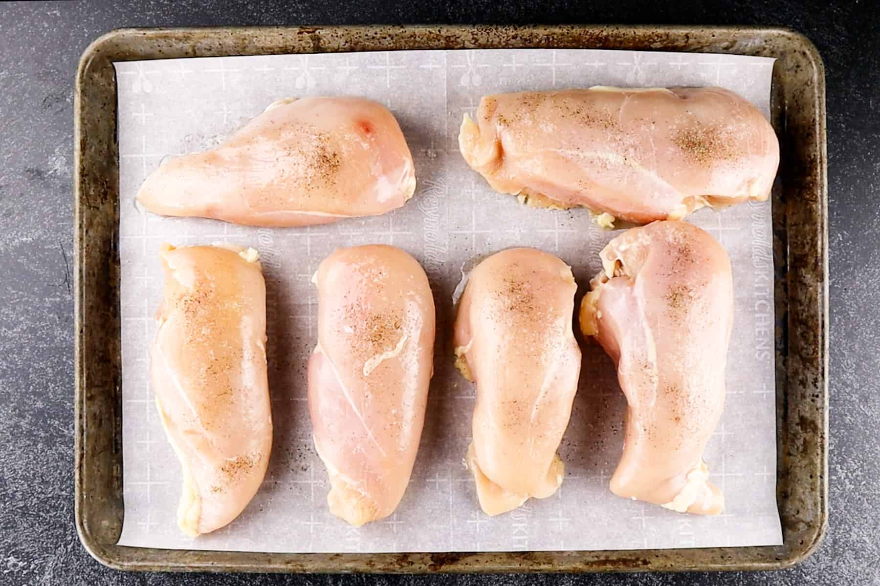 chicken breasts on baking sheet uncooked