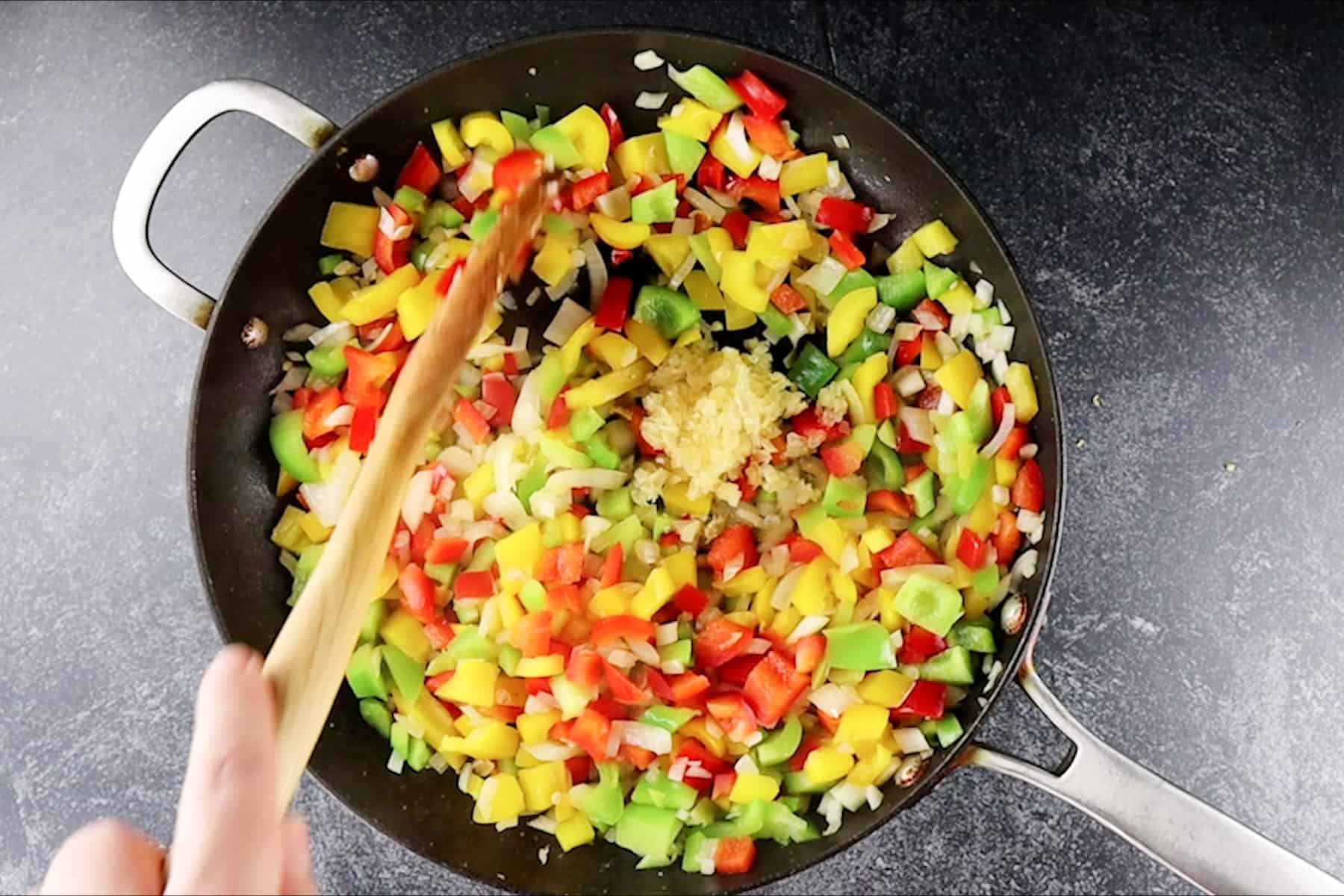 adding garlic to skillet