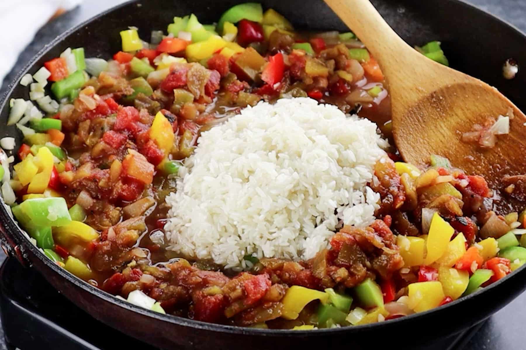 adding rice to skillet