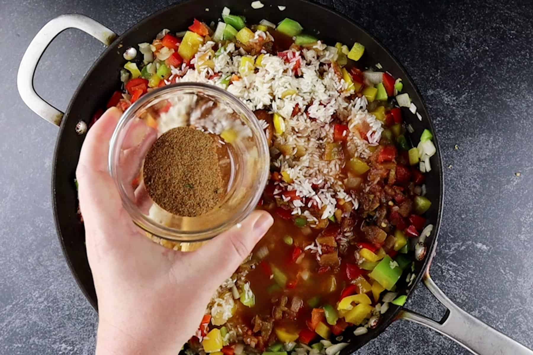 adding spiced to rice