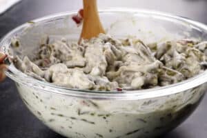 mixing the green beans into the cream cheese mixture