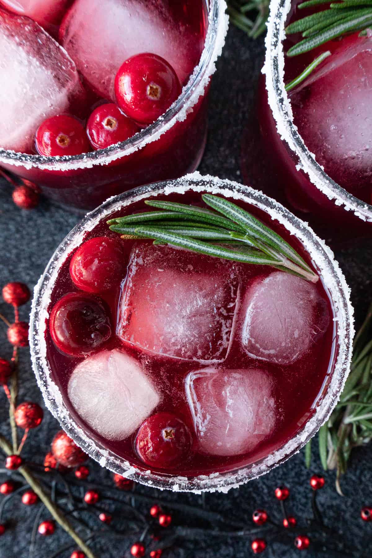 top down view of cranberry margarita in glass with garnishes