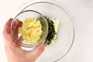 adding garlic to butter